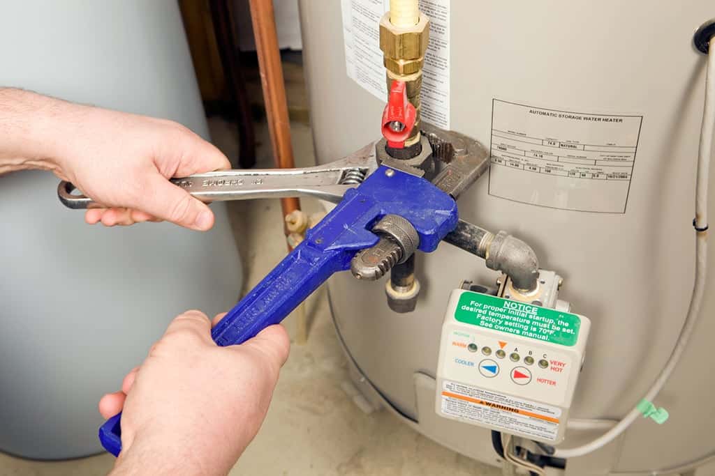 plumber getting ready to flush a water heater